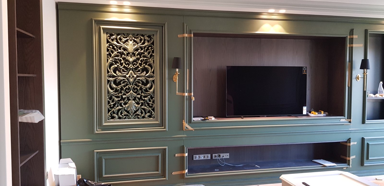 The green panelled media wall during installation