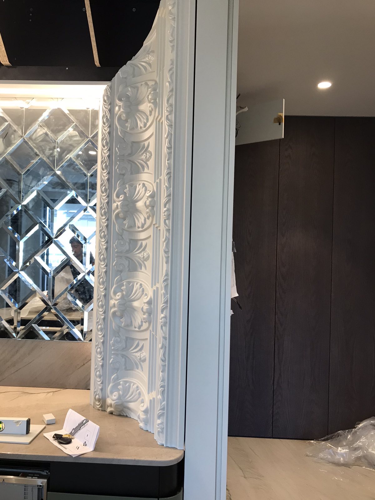 The carved mirror frame fitted beside the kitchen