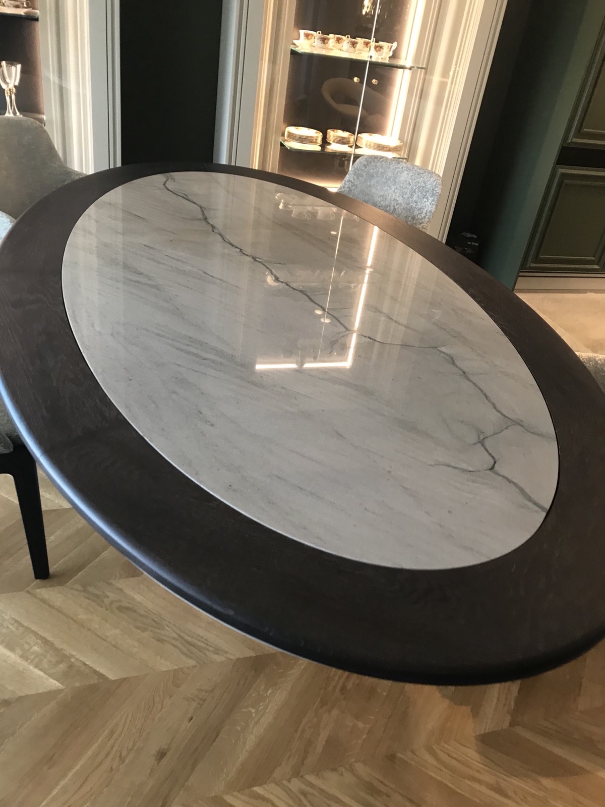 The bespoke dining table with a quartzite top set within a dark timber ring