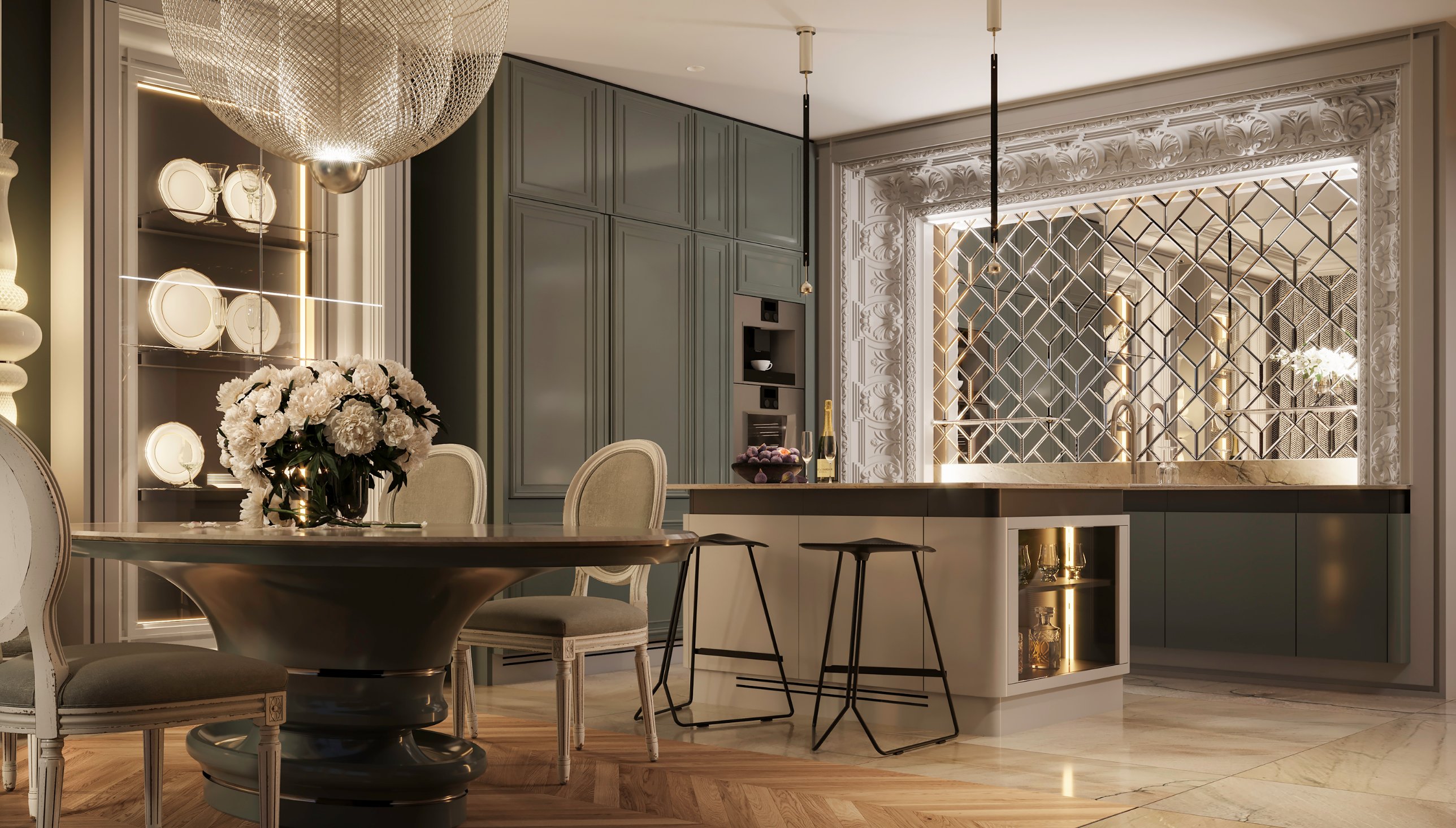 Green panelled kitchen with bar stools at the island and a mirrored splashback framed in carved ornament