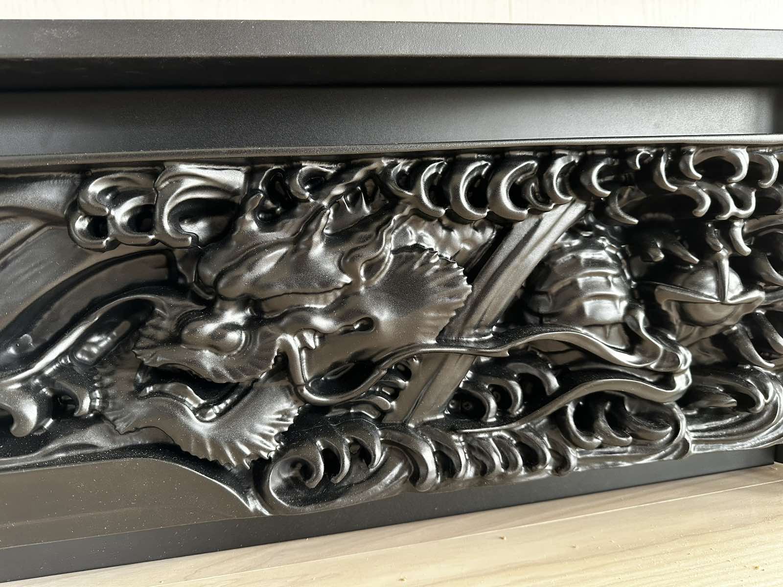 A black carved dragon relief