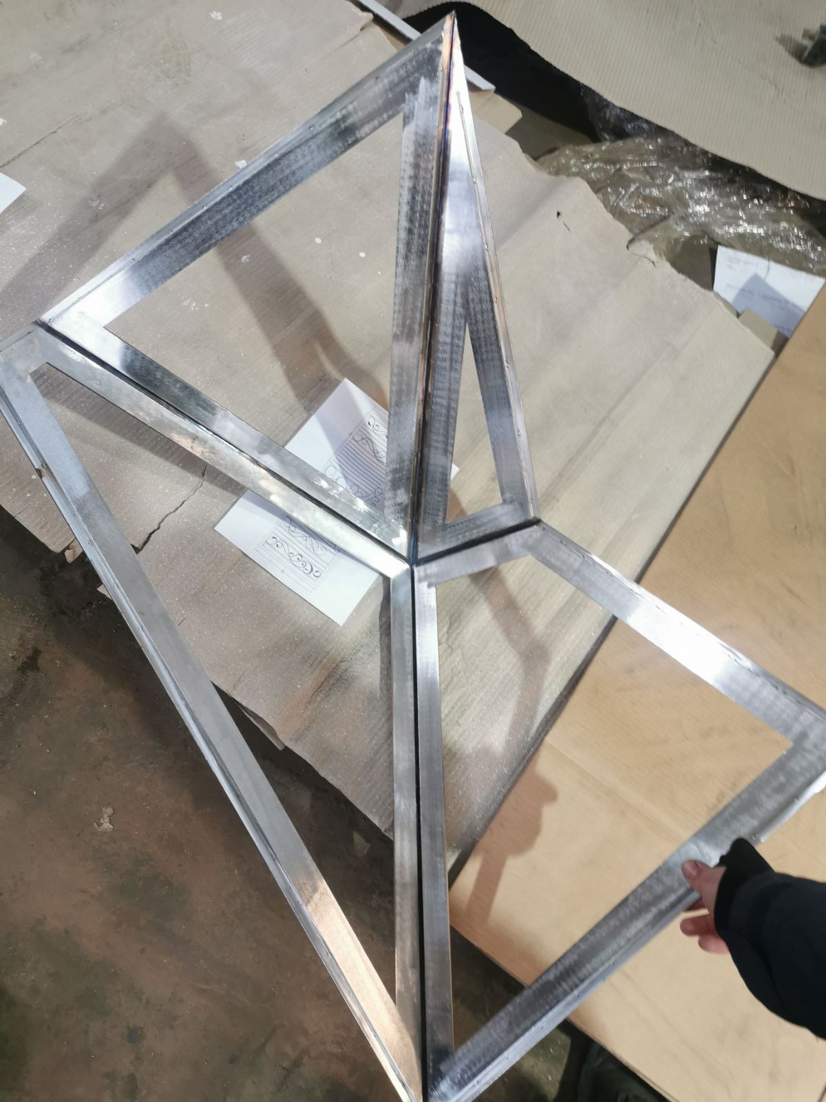 Welded stainless-steel triangles forming a faceted frame