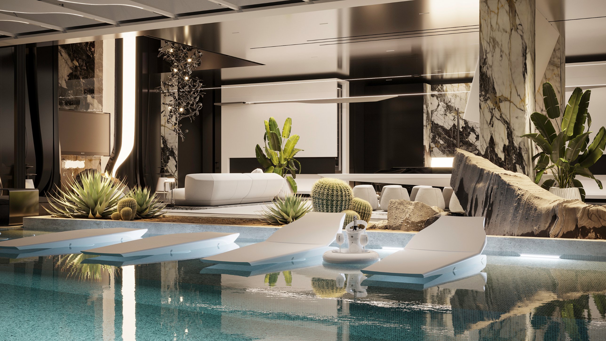 White loungers set on the Baja shelf, with a floating champagne cooler and a rock garden beyond