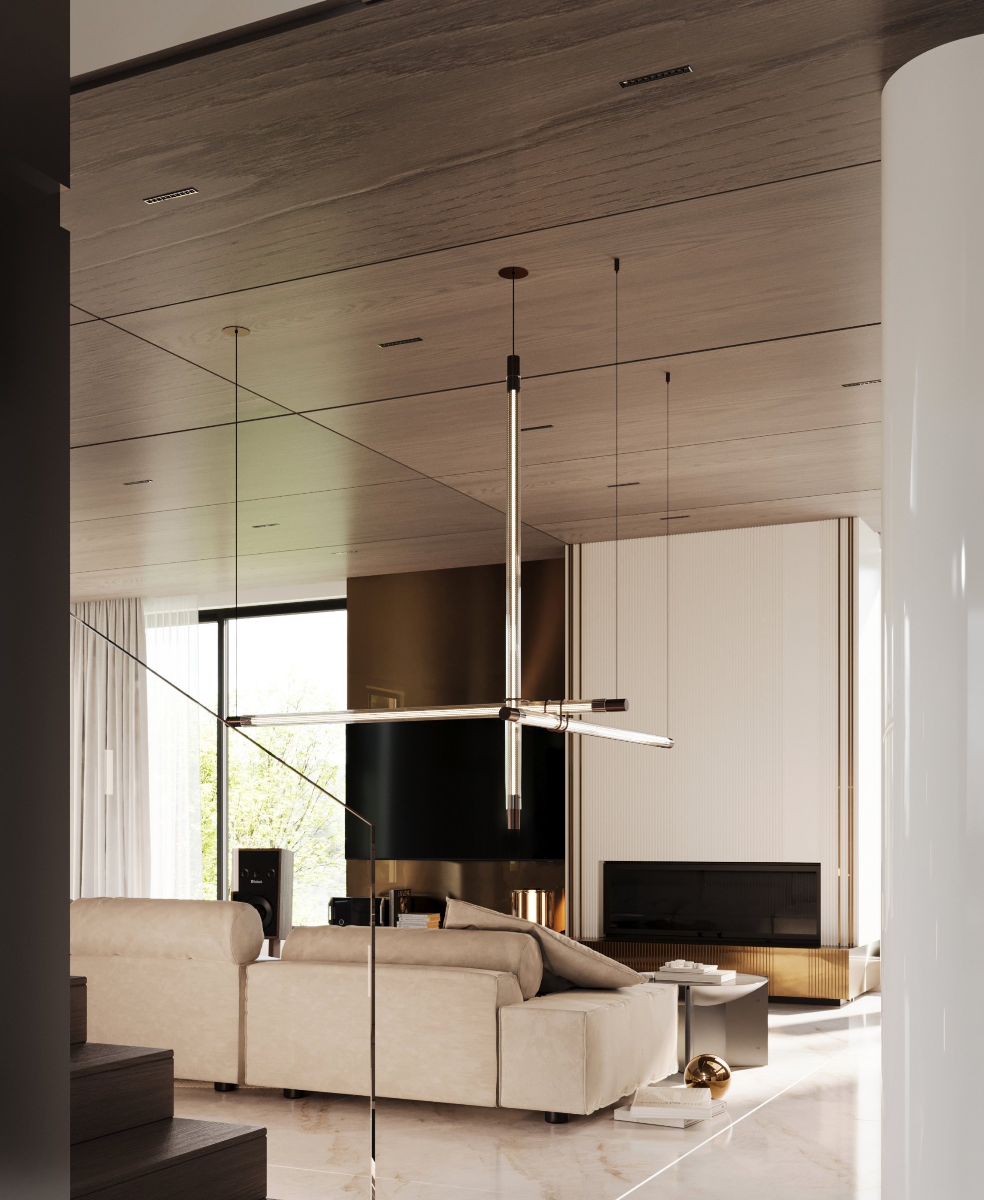 Crossed glass pendants above the sofa, with the bronze media wall and fluted fireplace beyond