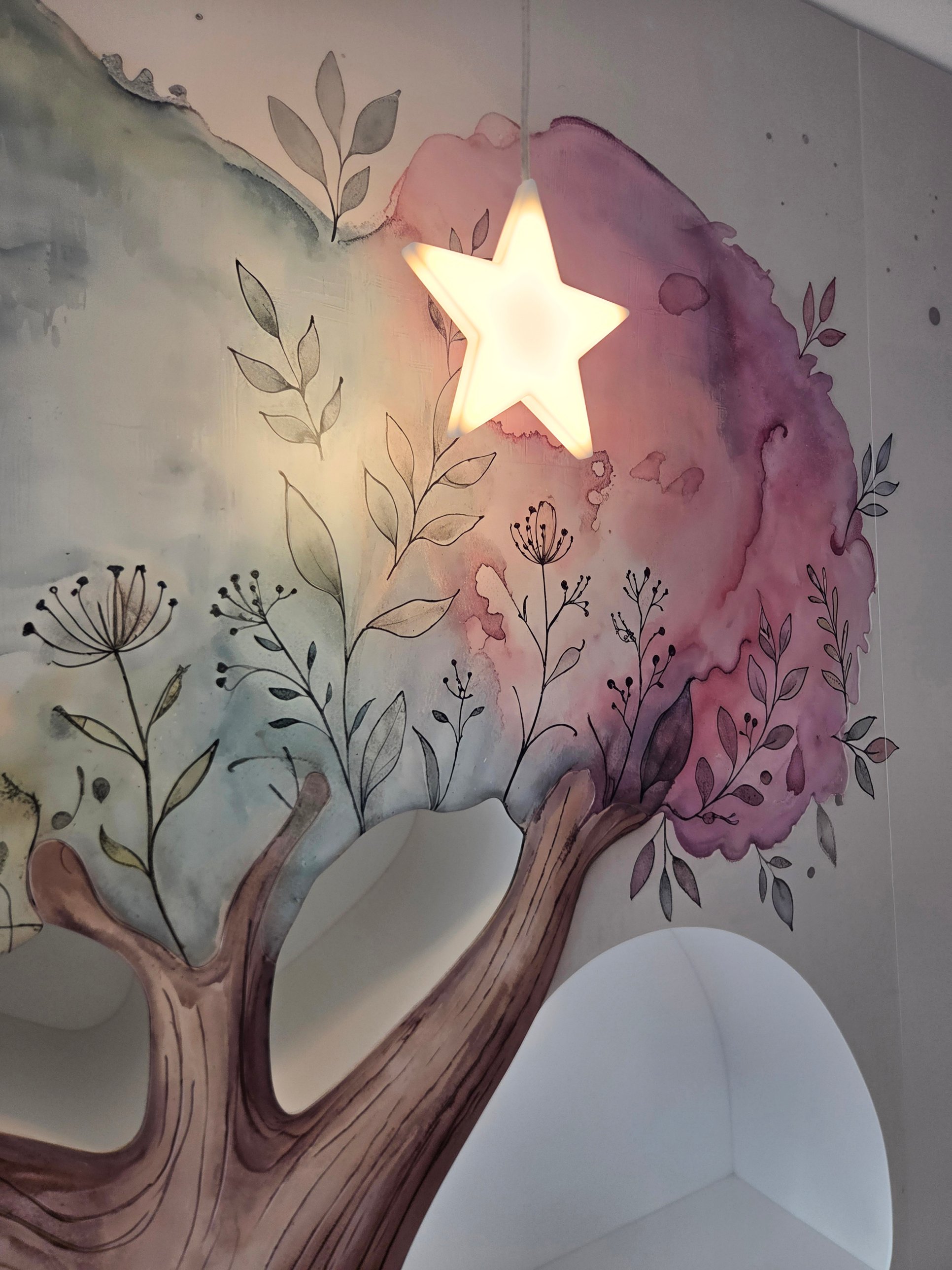 The finished tree mural with a glowing star light