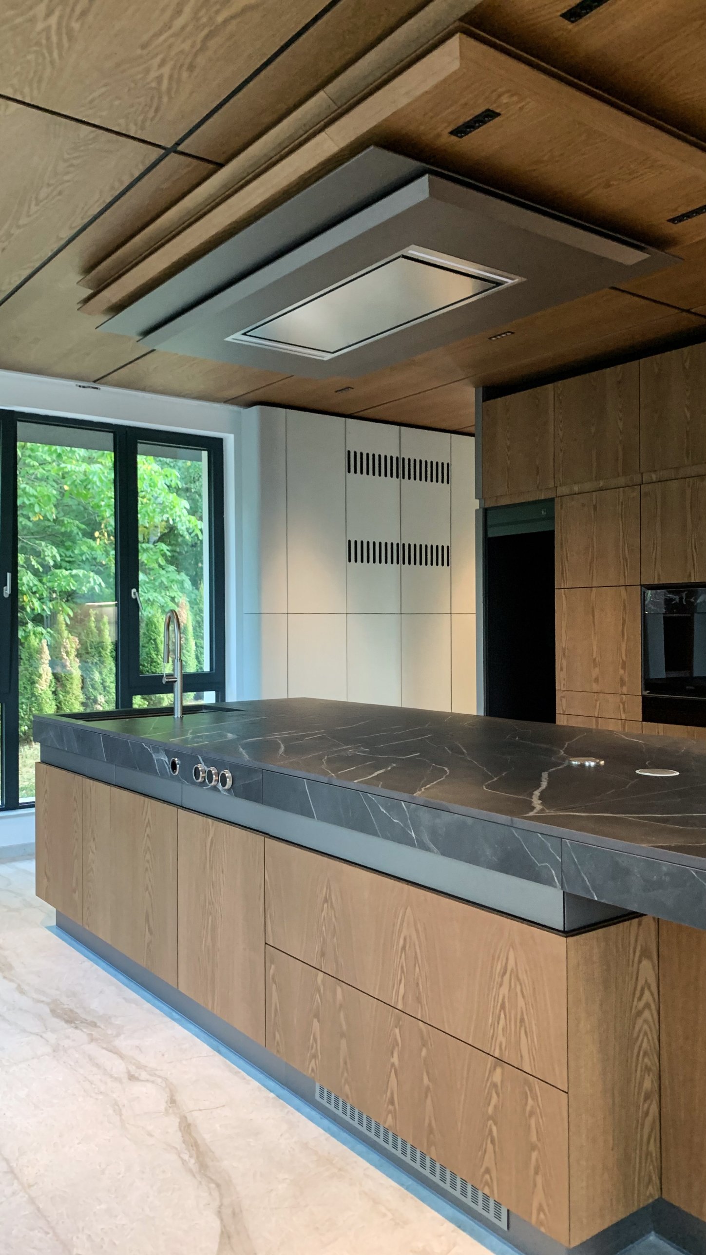 The timber and stone kitchen island on site