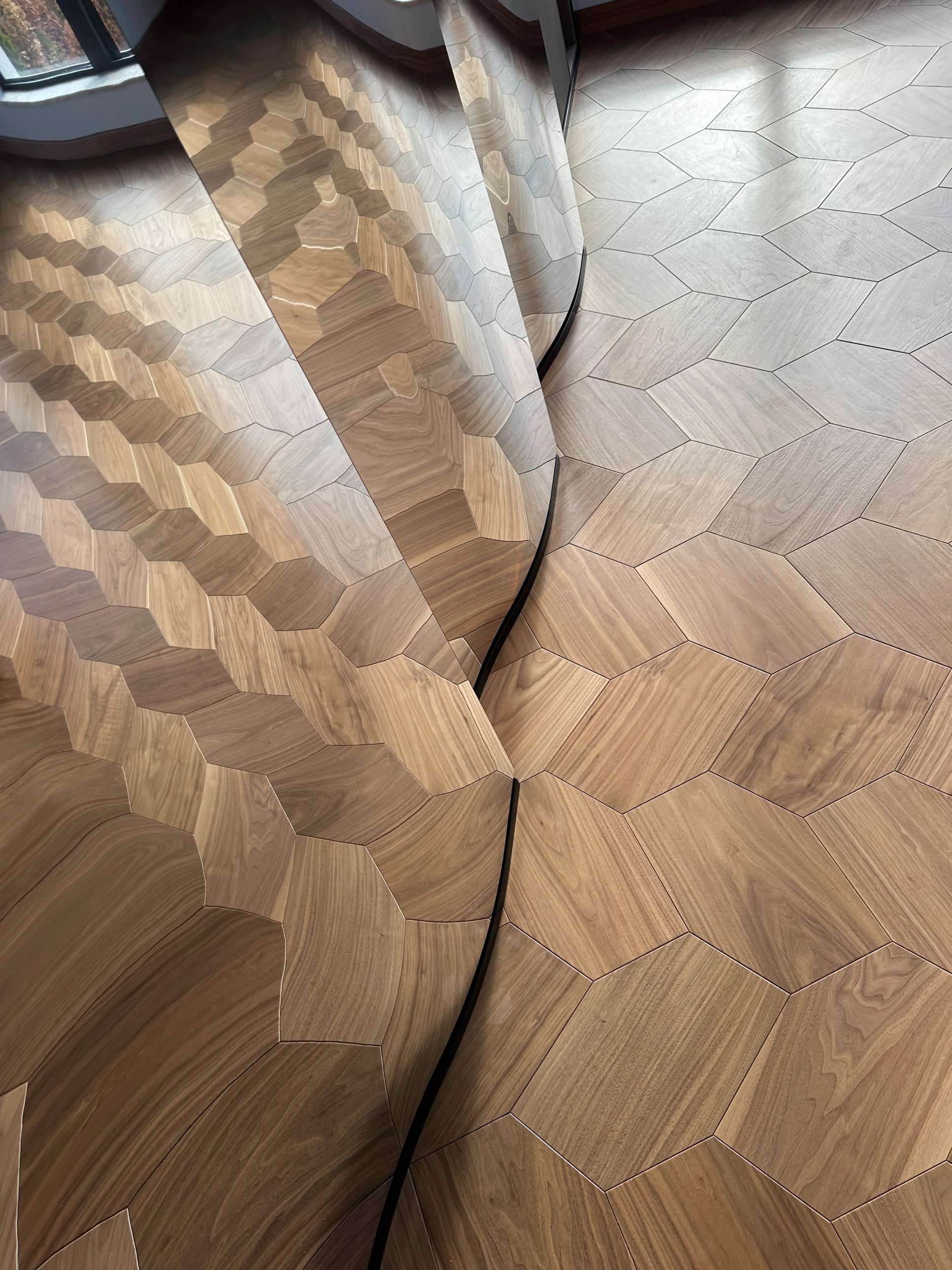 The timber floor reflected in the curved mirror