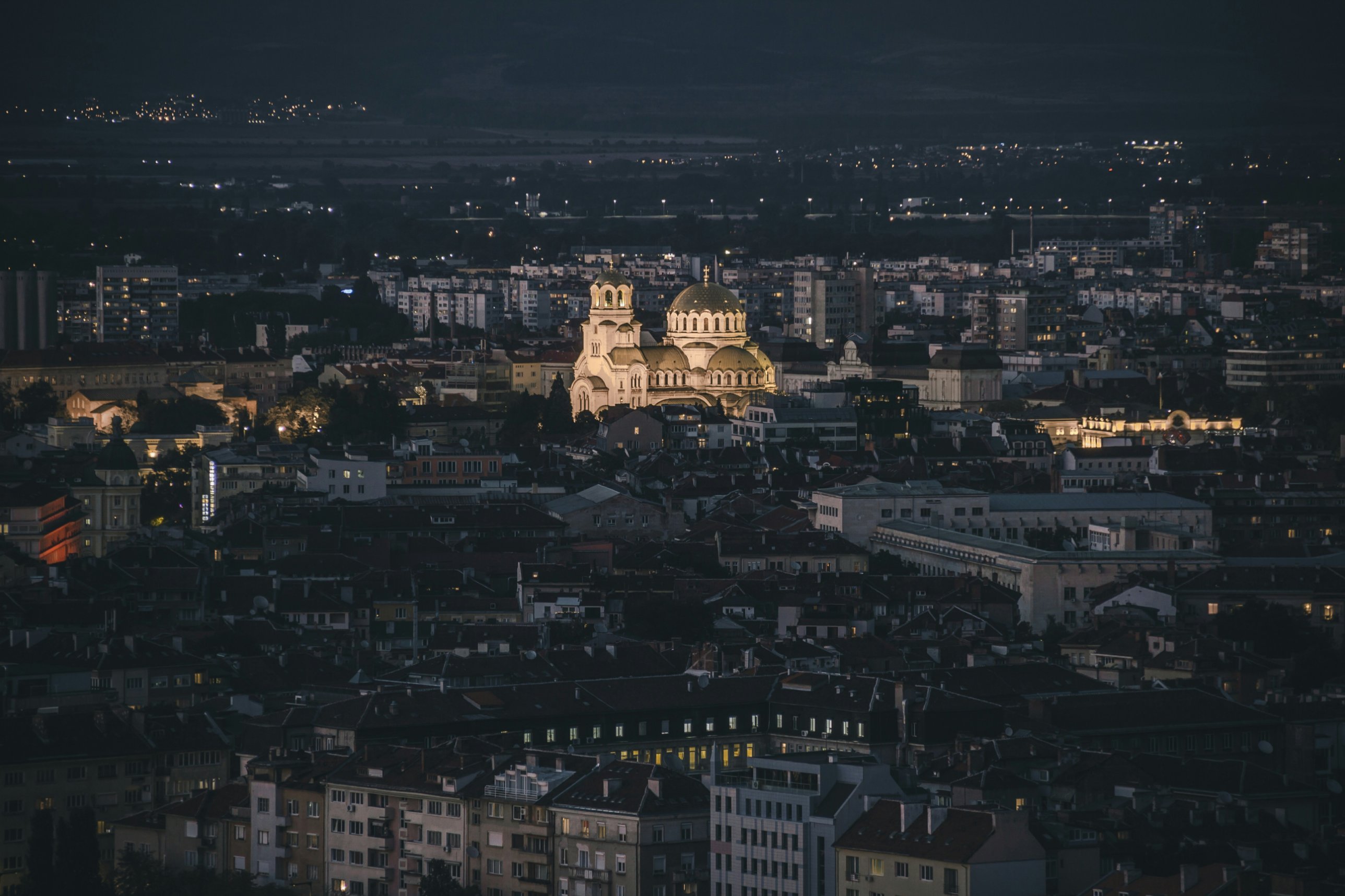 Sofia at dusk, with the illuminated Alexander Nevsky Cathedral among the rooftops
