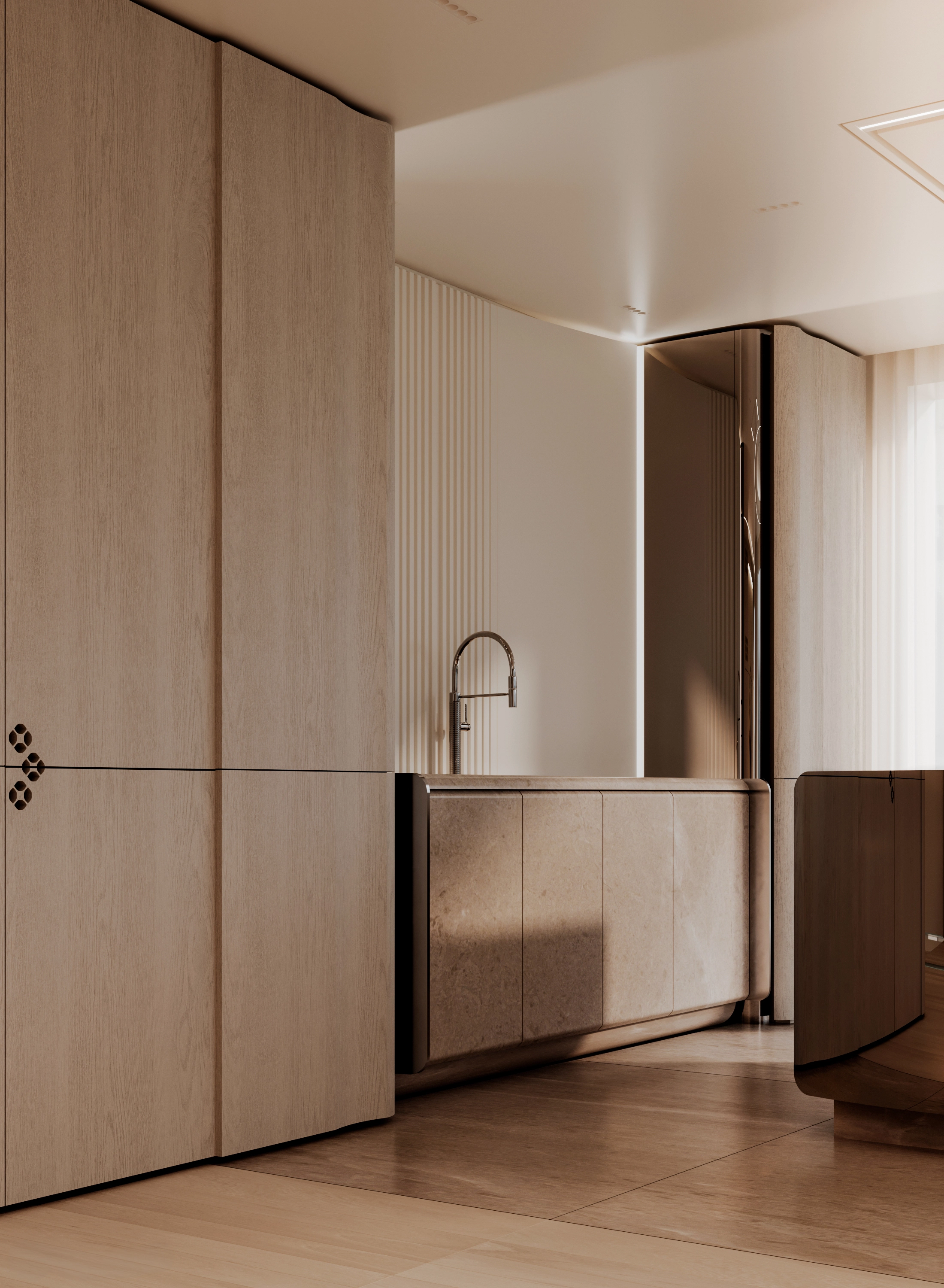 Stone kitchen elements beside oak joinery and the mirror-polished island