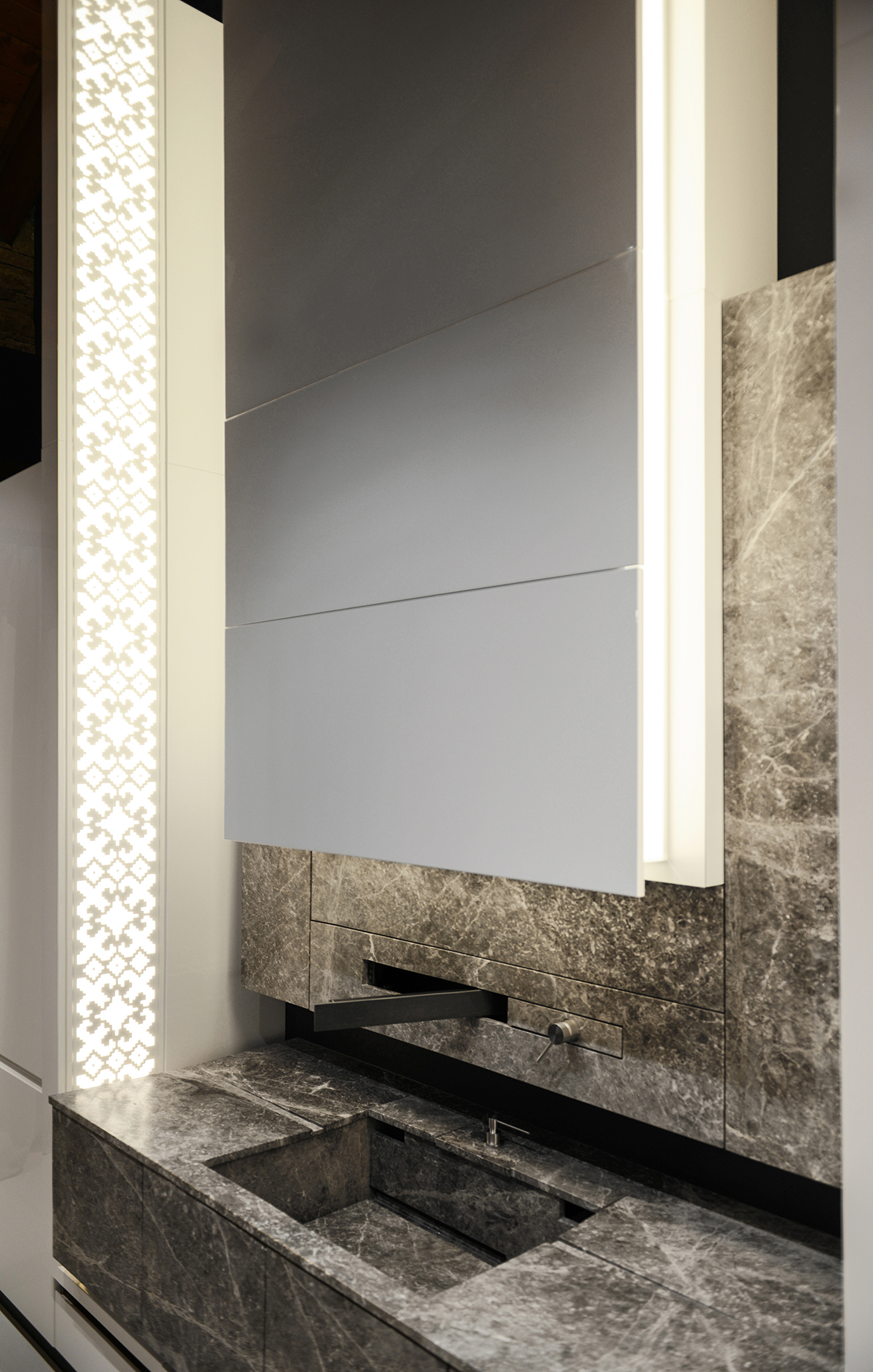 Stone-clad kitchen wall and sink beside an illuminated pattern panel