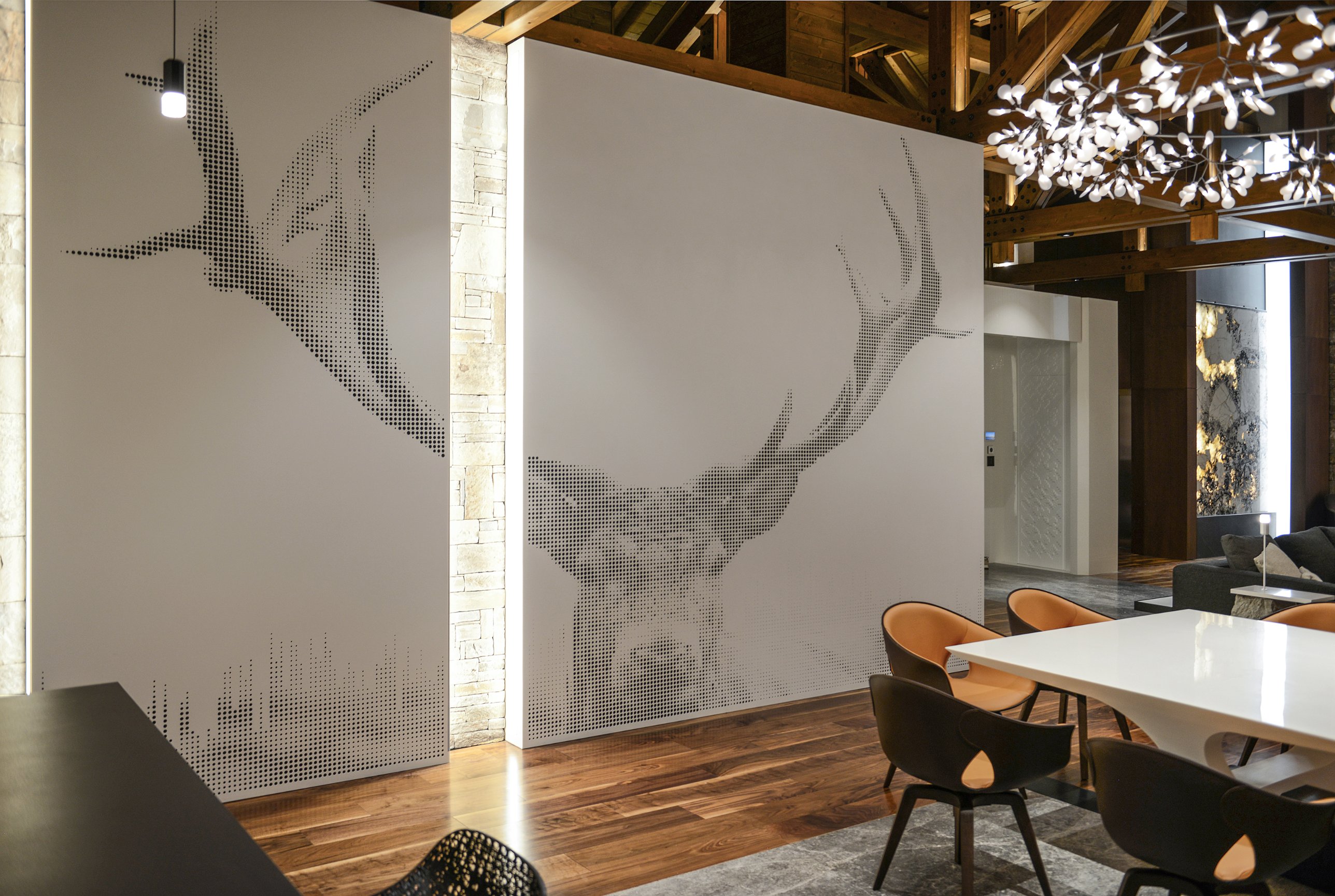 The perforated stag image across two white wall panels beside the dining area
