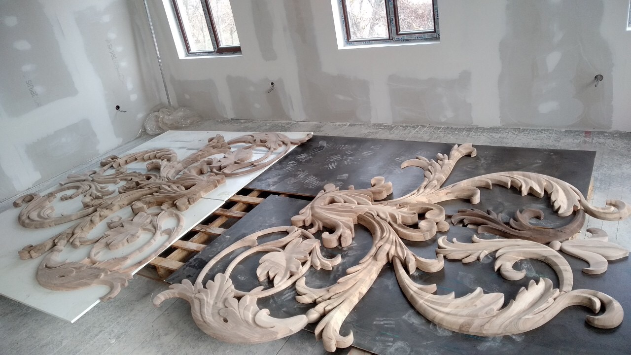 Carved timber ornament laid out before installation