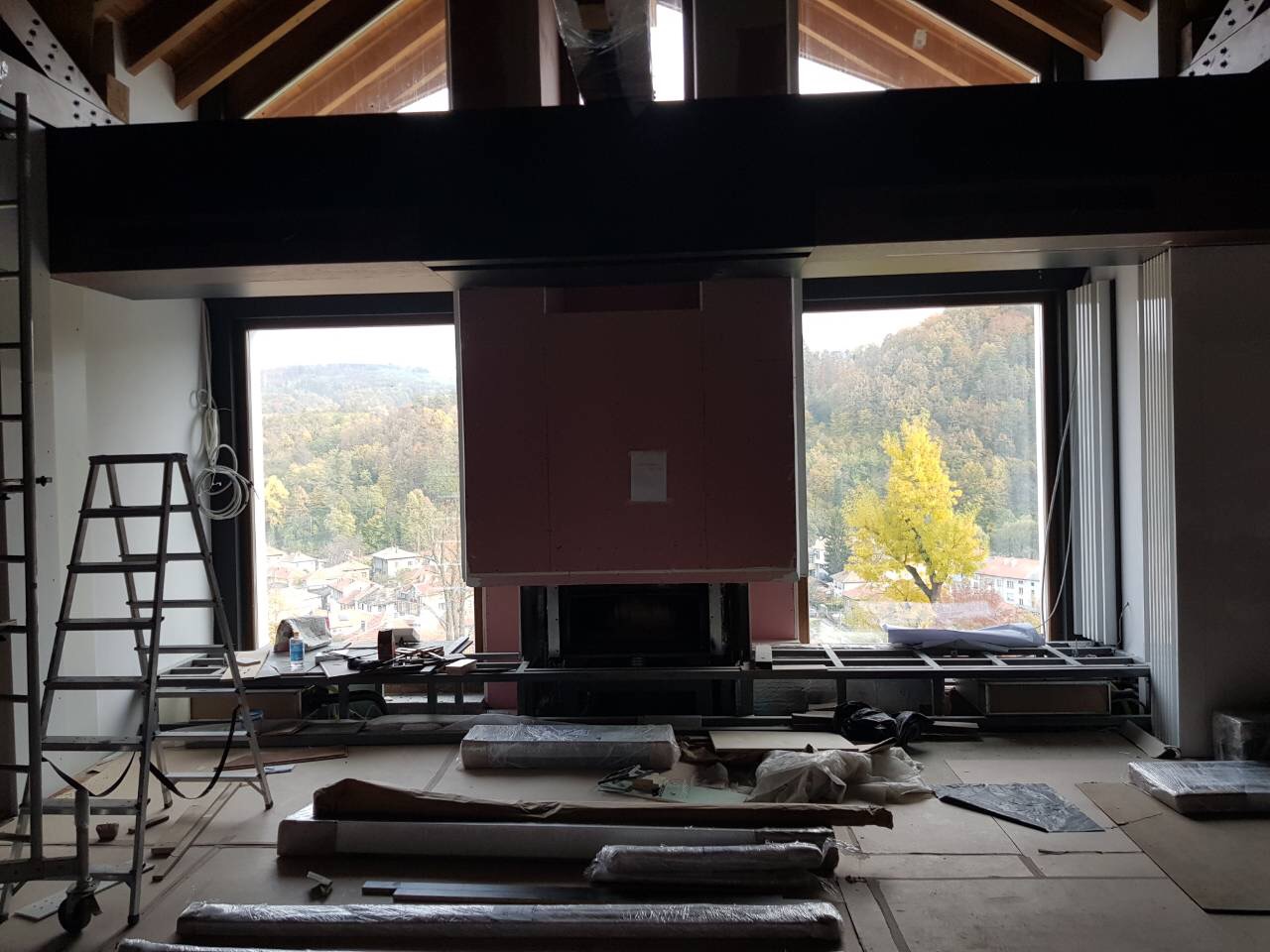 The fireplace volume framed between the windows