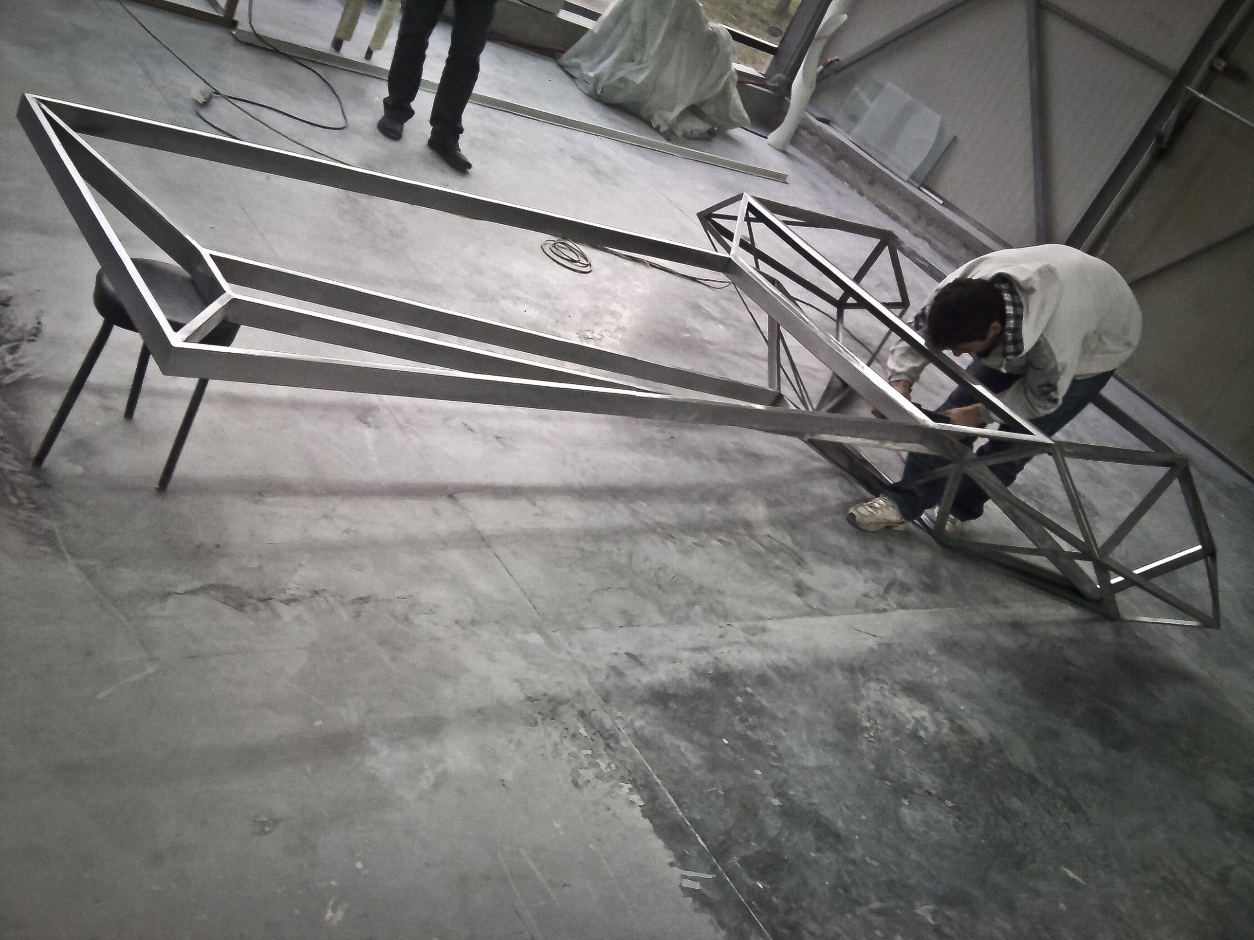 The complete steel frame of the desk and conference table before glazing