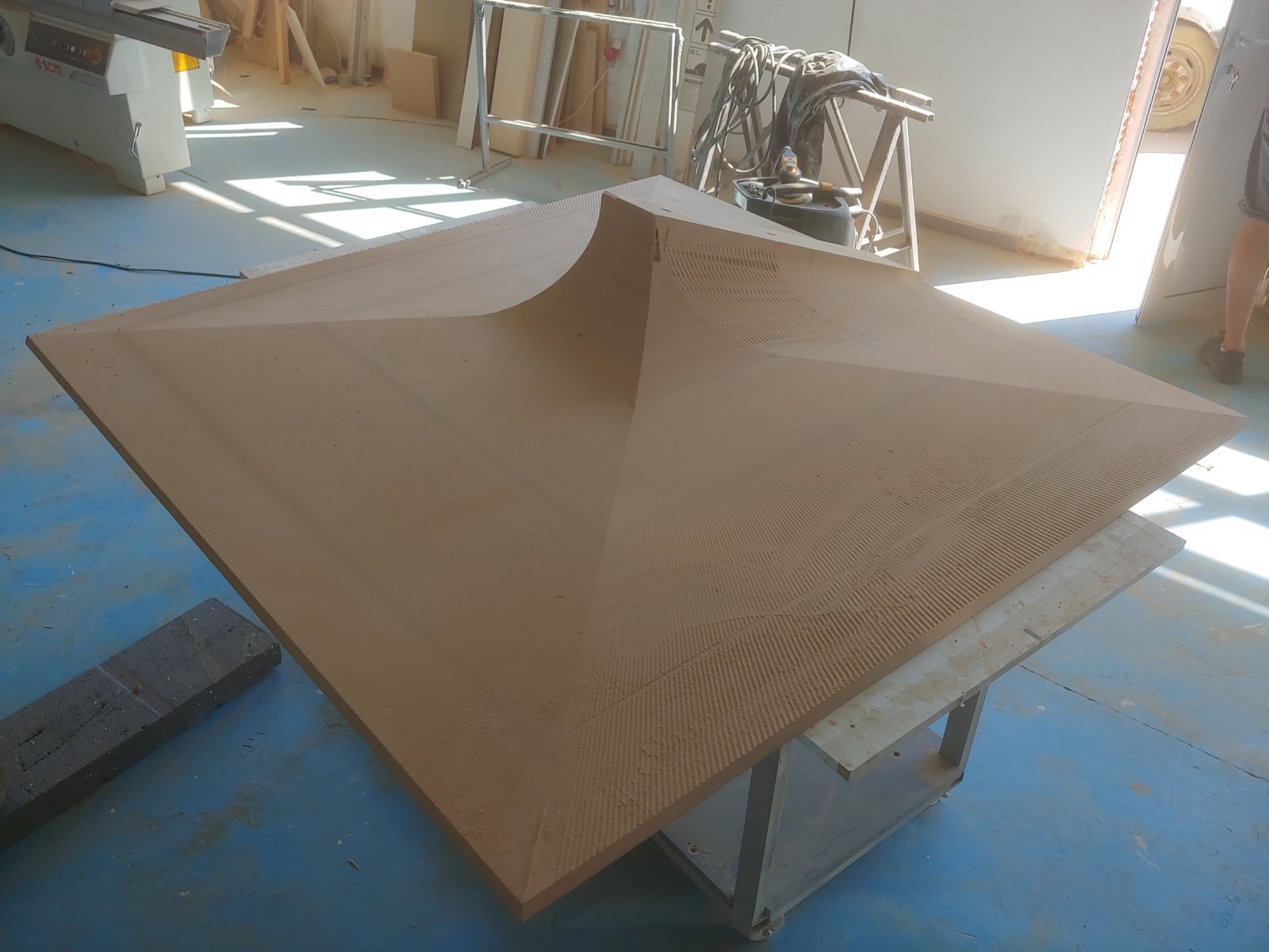 A faceted relief panel in the workshop