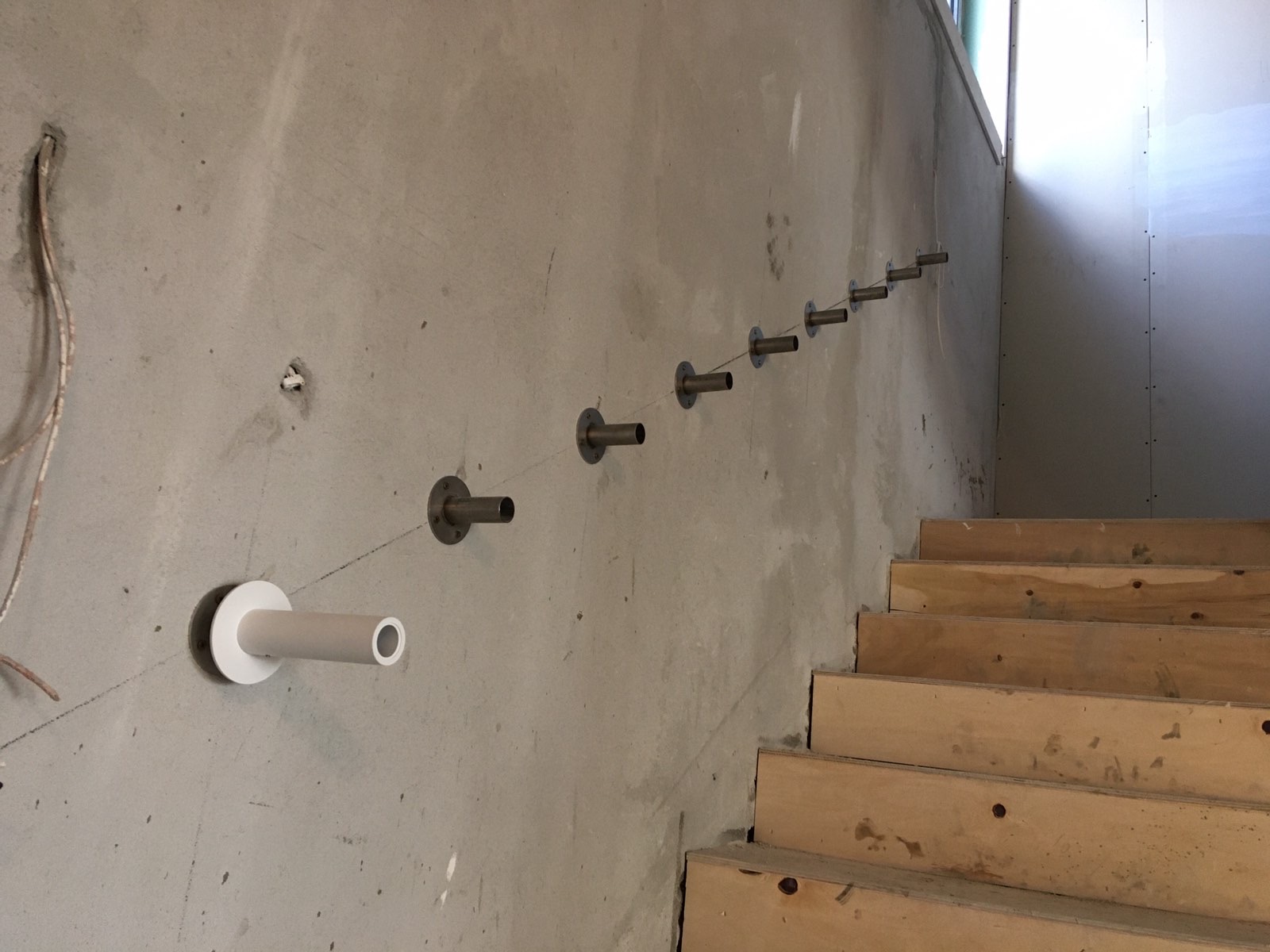 Handrail fixings set into the concrete stair wall