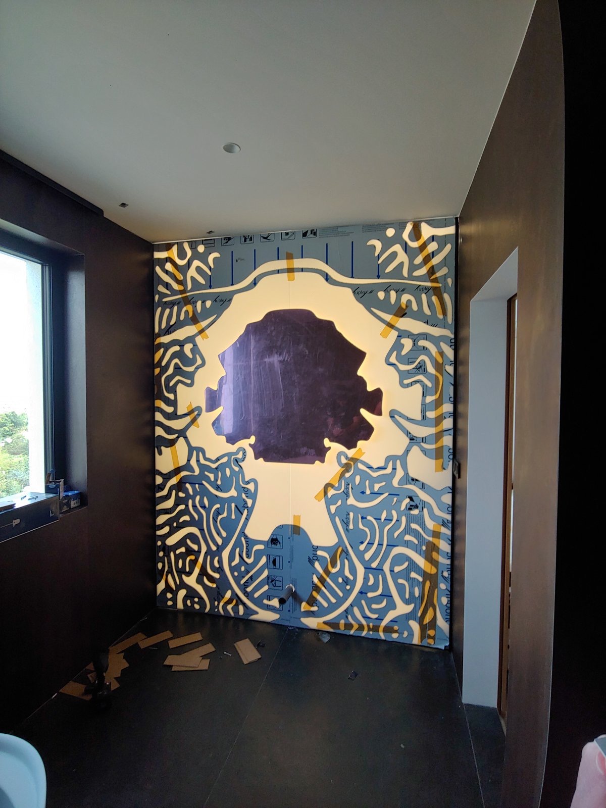 The illuminated bathroom wall installed with its protective film