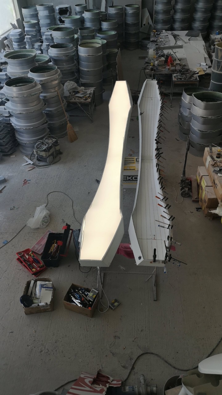 The two halves of the lighting sculpture, one lit, during assembly